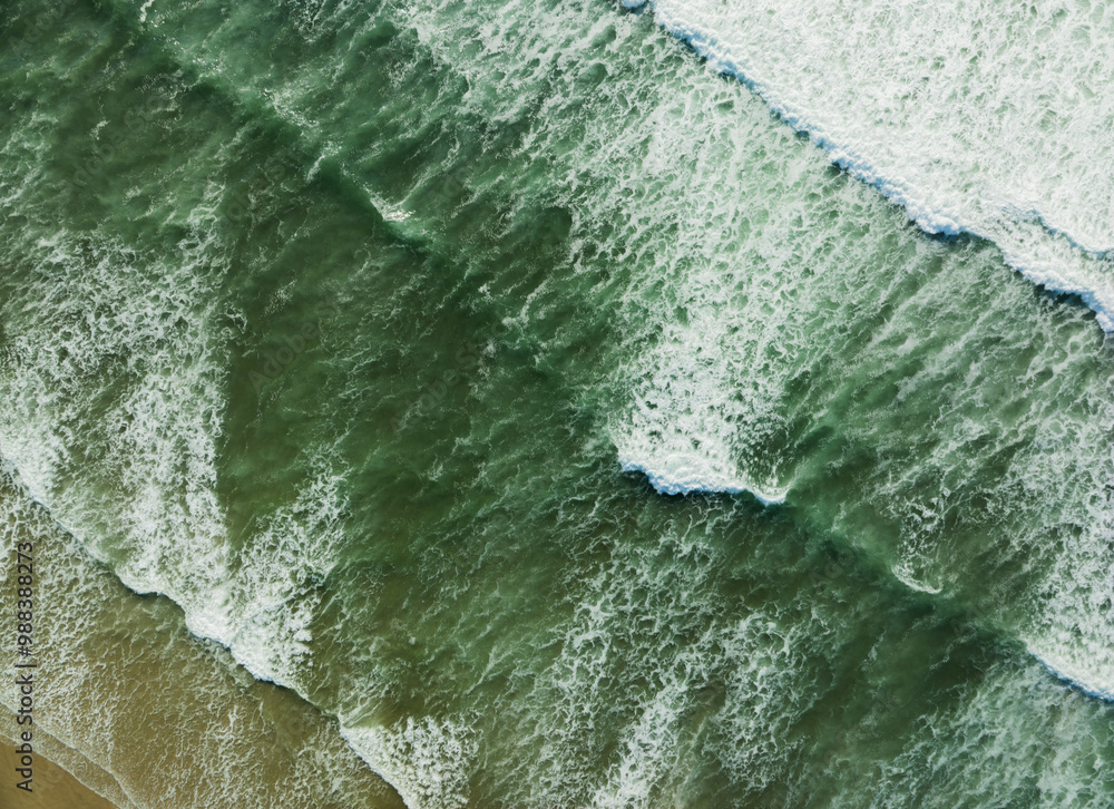 A beautiful ocean with green waves crashing against the shore A beautiful ocean with green waves crashing against the shore