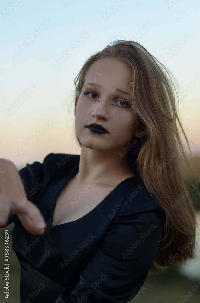 young girl dancing in a black dress like a witch for Halloween young girl dancing in a black dress like a witch for Halloween