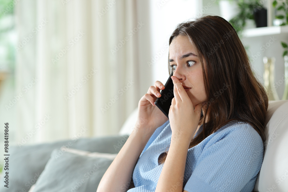 Worried woman talking on phone at home Worried woman talking on phone at home