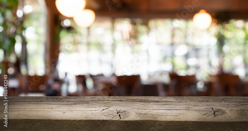 Rustic wooden table top with a blurred background of a restaurant interior. Perfect for showcasing your products.