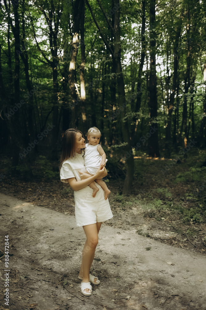 A mother with a baby walking in the forest A mother with a baby walking in the forest