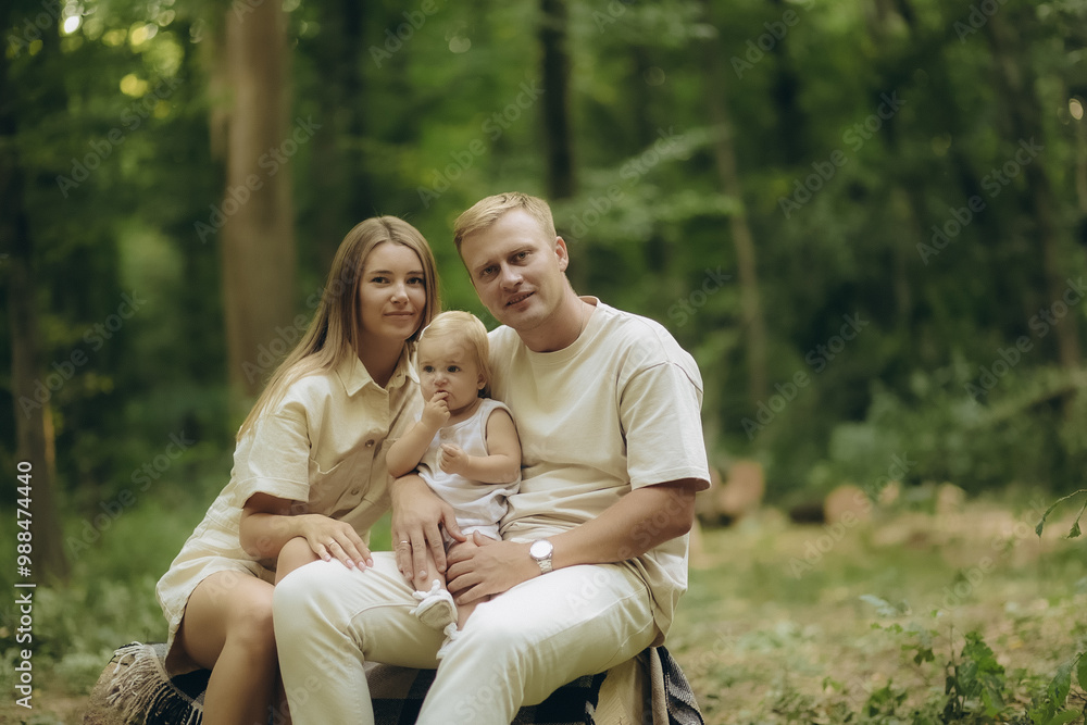 a young family on a picnic in the forest a young family on a picnic in the forest