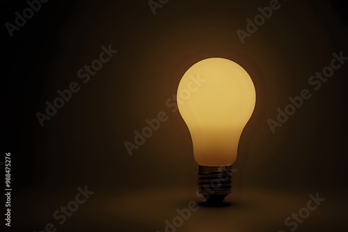 Matte light bulb emitting warm glow on a dark background for creative concepts