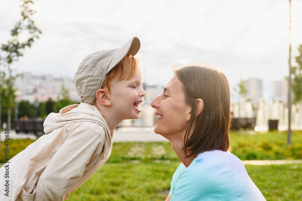 Playful mother with son in park Playful mother with son in park
