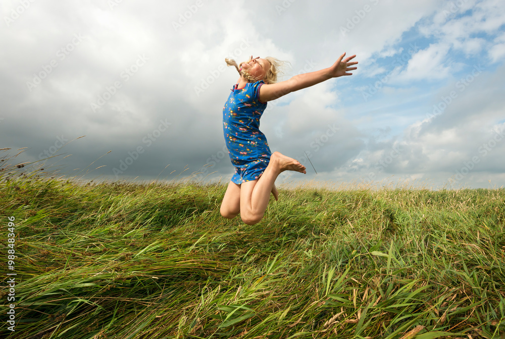 Joyful girl jumping in agricultural field Joyful girl jumping in agricultural field