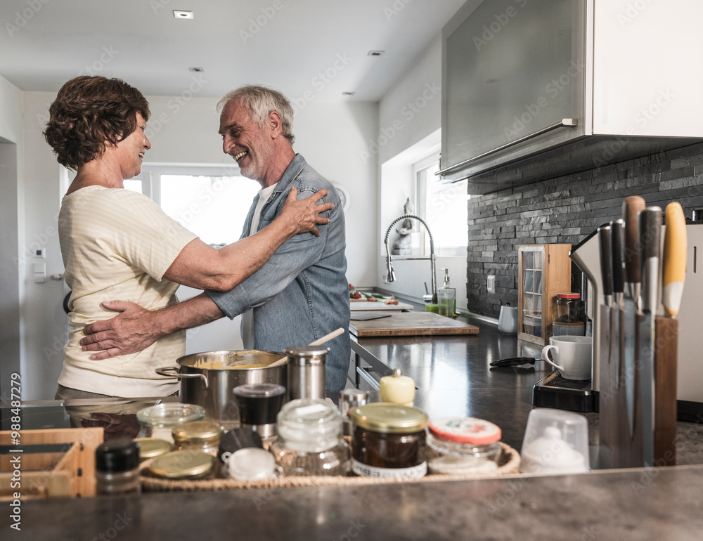 Happy senior couple dancing in kitchen at home Happy senior couple dancing in kitchen at home