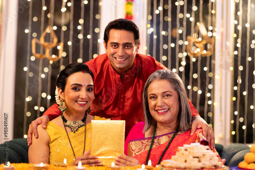 Two generation family celebrating Diwali festival at home photo