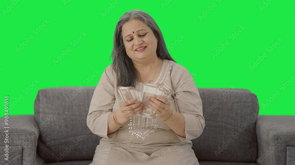 Happy Indian old woman counting money Green screen Happy Indian old woman counting money Green screen
