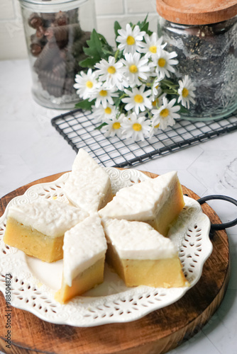 Kuih Talam Pisang, a steamed dessert made with banana and rice flour, featuring a soft, layered texture and sweet, creamy flavor. photo