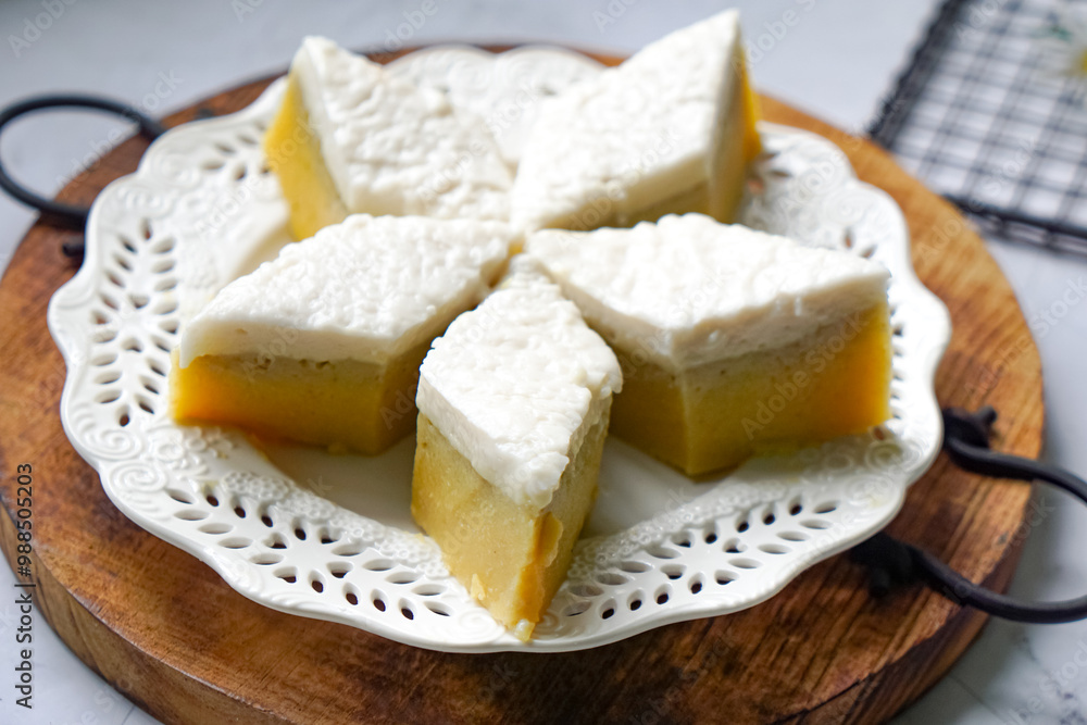 Kuih Talam Pisang, a steamed dessert made with banana and rice flour, featuring a soft, layered texture and sweet, creamy flavor. Kuih Talam Pisang, a steamed dessert made with banana and rice flour, featuring a soft, layered texture and sweet, creamy flavor.