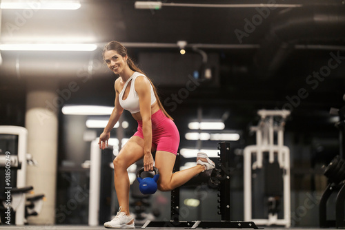 Wallpaper Mural Tough muscular sportswoman in shape doing romanian squat with kettlebell at gym. Torontodigital.ca