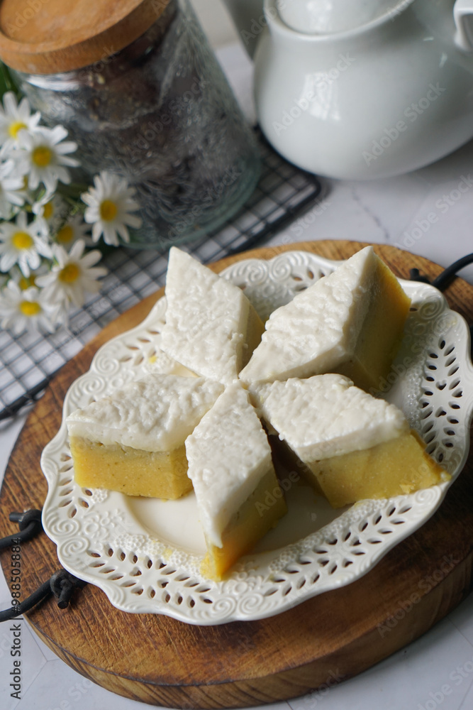 Kuih Talam Pisang, a steamed dessert made with banana and rice flour, featuring a soft, layered texture and sweet, creamy flavor. Kuih Talam Pisang, a steamed dessert made with banana and rice flour, featuring a soft, layered texture and sweet, creamy flavor.