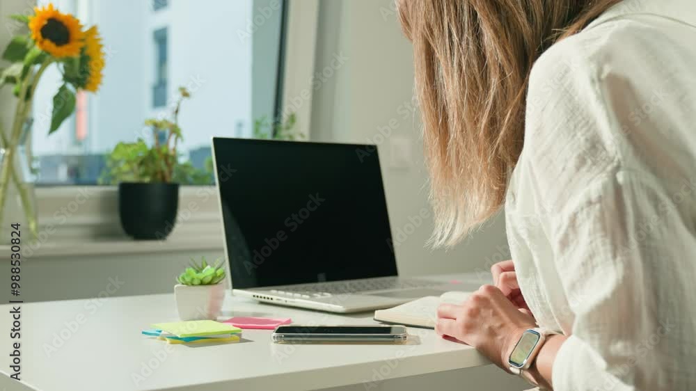 Person is sketching in notebook while working remotely at desk with laptop. Freelance work at home office. Graphic designer drawing sketch Person is sketching in notebook while working remotely at desk with laptop. Freelance work at home office. Graphic designer drawing sketch