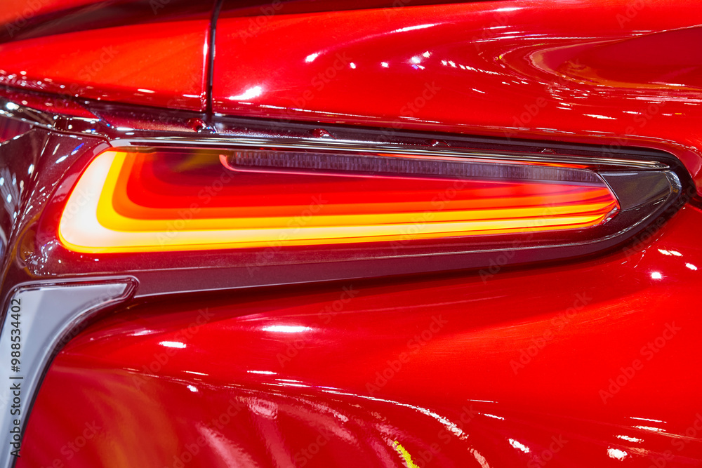 Red car rear light detail. Elegant design car lights. Motor industry