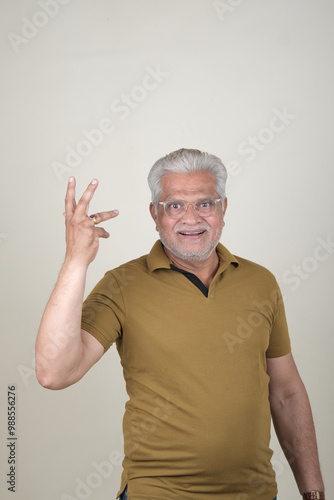 Confident Mature Man Smiling in Casual Attire, Embracing Life's Simplicity and Joy.