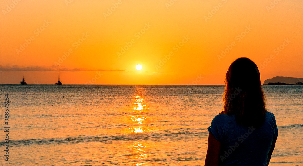 Fototapeta premium a woman watching a sunset on a torpical beach generated with artificial intelligence