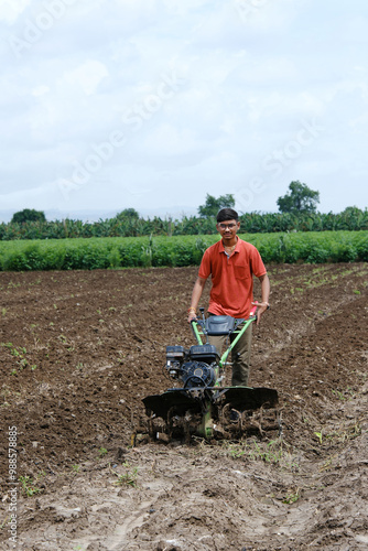 Growing with Technology: A Proud Farmer Showcasing His Thriving Cotton Fields