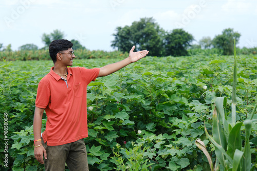 Growing with Technology: A Proud Farmer Showcasing His Thriving Cotton Fields