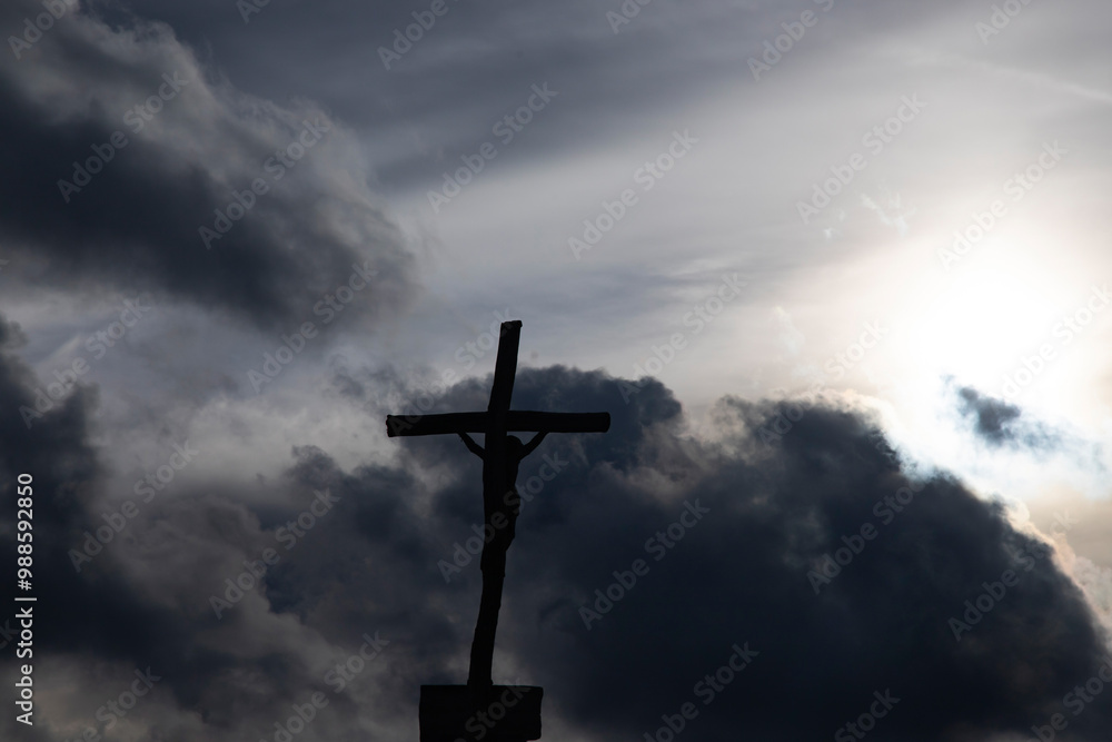 Passion Week cross silhouette with dramatic sky symbolizing the sacrifice, suffering, death, resurrection and passion of Jesus Passion Week cross silhouette with dramatic sky symbolizing the sacrifice, suffering, death, resurrection and passion of Jesus