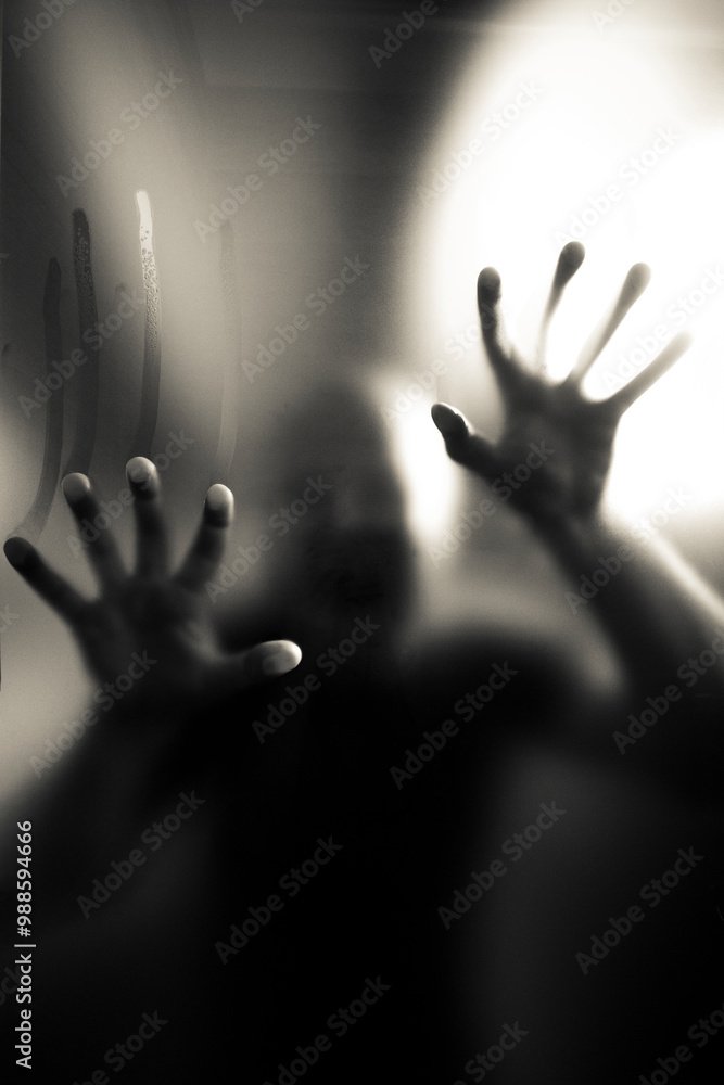 Scary picture of hands behind glass, horror ghost behind door, Halloween concept Scary picture of hands behind glass, horror ghost behind door, Halloween concept