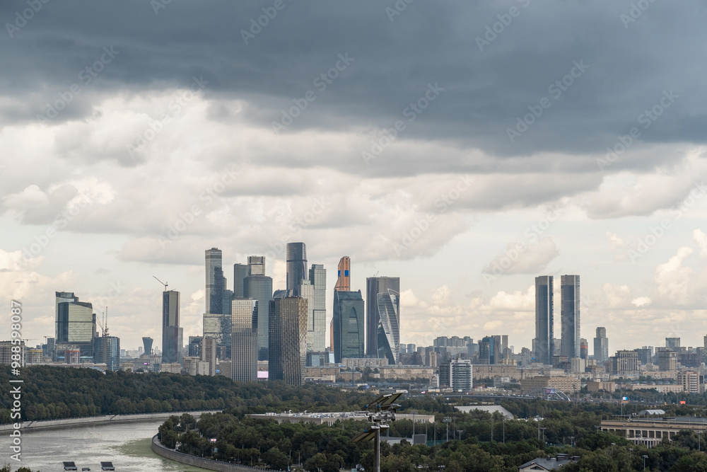 The skyline of Moscow City stands tall against a backdrop of dramatic clouds as Luzhniki Park stretches below in the afternoon light The skyline of Moscow City stands tall against a backdrop of dramatic clouds as Luzhniki Park stretches below in the afternoon light