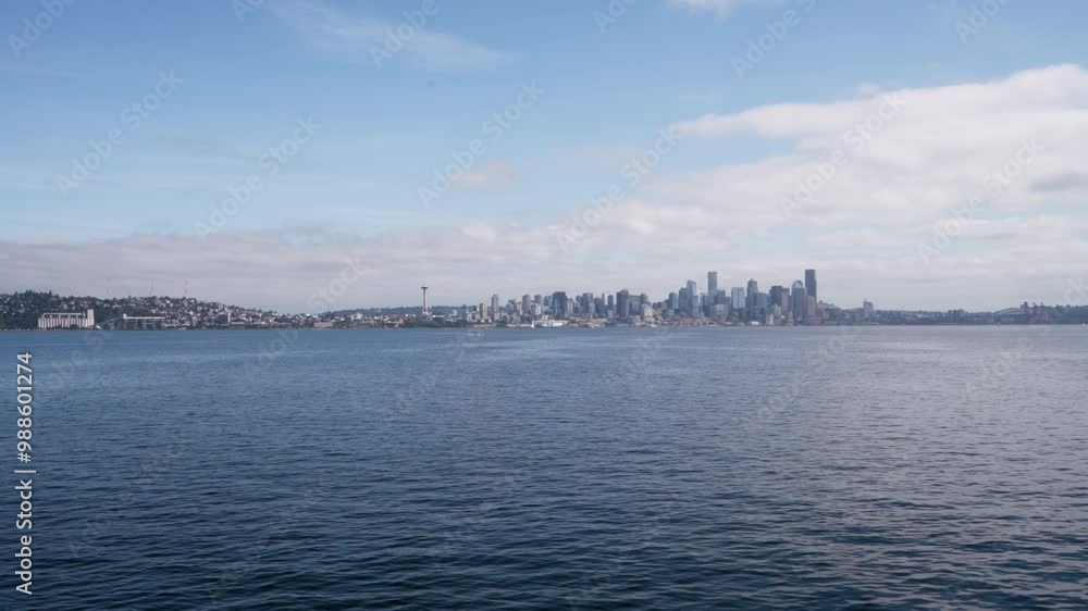 Hyperlapse showing Seattle’s skyline from a ferry crossing Elliott Bay, highlighting the Space Needle and waterfront buildings under clear skies Hyperlapse showing Seattle’s skyline from a ferry crossing Elliott Bay, highlighting the Space Needle and waterfront buildings under clear skies