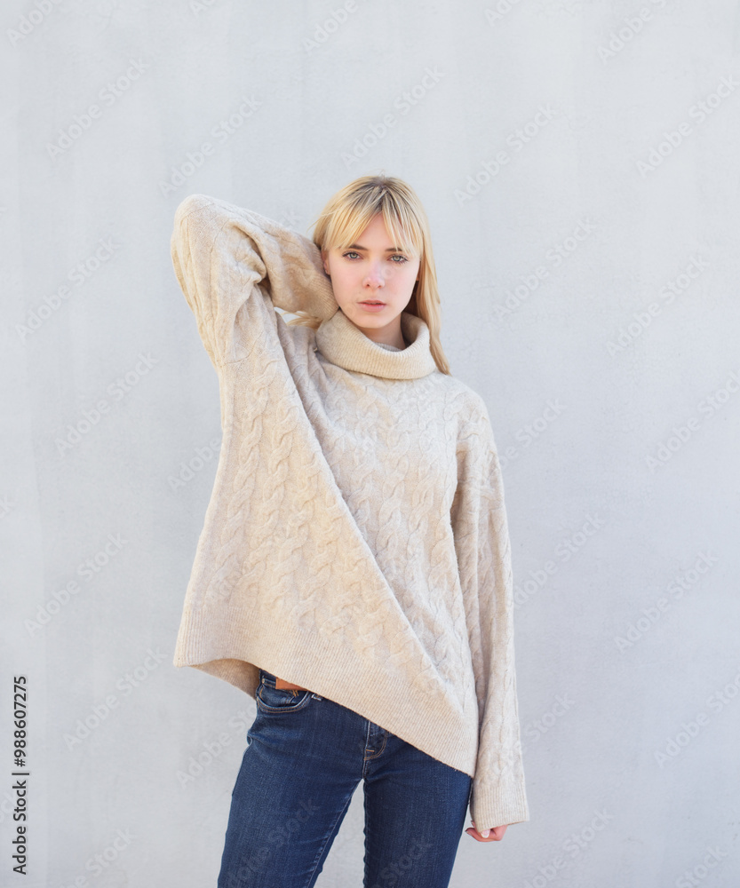 Outdoor portrait of young woman in beige sweater. Outdoor portrait of young woman in beige sweater.