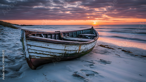 A quiet beach at sunset with a weathered fishing boat moored near the shore.