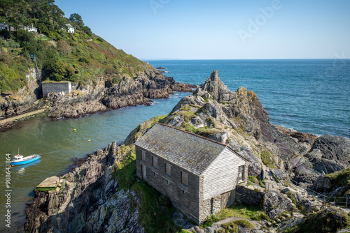 Polperro in Cornwall, sea, cliffs, blue sky and rocks photo