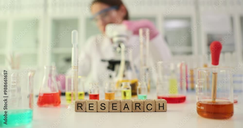 Word Research on lab assistant workbench with various glassware. Scientist conducts medical research in modern chemical laboratory Word Research on lab assistant workbench with various glassware. Scientist conducts medical research in modern chemical laboratory