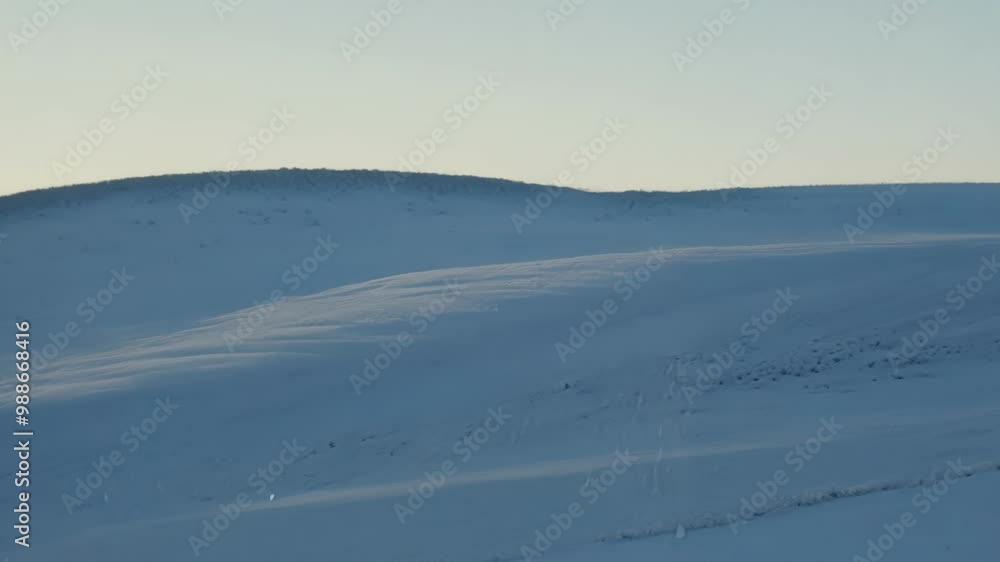 Smooth blanket of snow covers the rolling hills of iceland, creating a serene and minimalist winter landscape that stretches as far as the eye can see Smooth blanket of snow covers the rolling hills of iceland, creating a serene and minimalist winter landscape that stretches as far as the eye can see