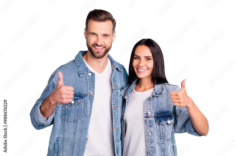 Portrait of charming spouses showing thumb up wearing denim jeans isolated over blue background Portrait of charming spouses showing thumb up wearing denim jeans isolated over blue background