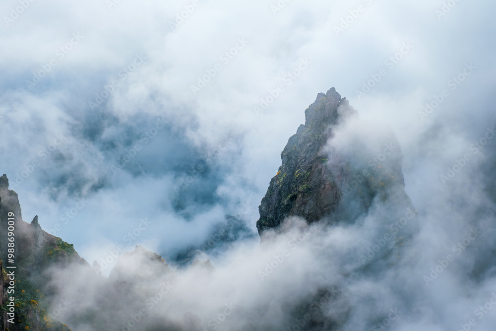 Obraz premium A mountain covered in fog and clouds. Near Pico de Arieiro , Madeira island, Portugal