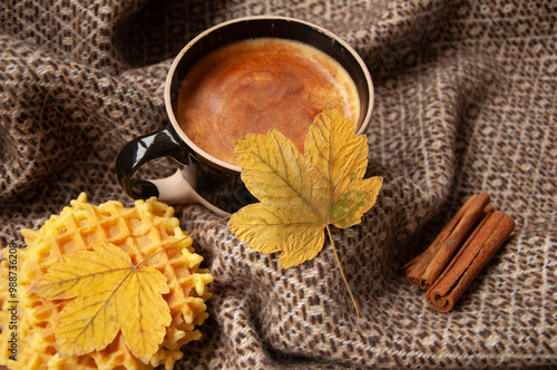 Cozy autumn coffee with leaves and a blanket