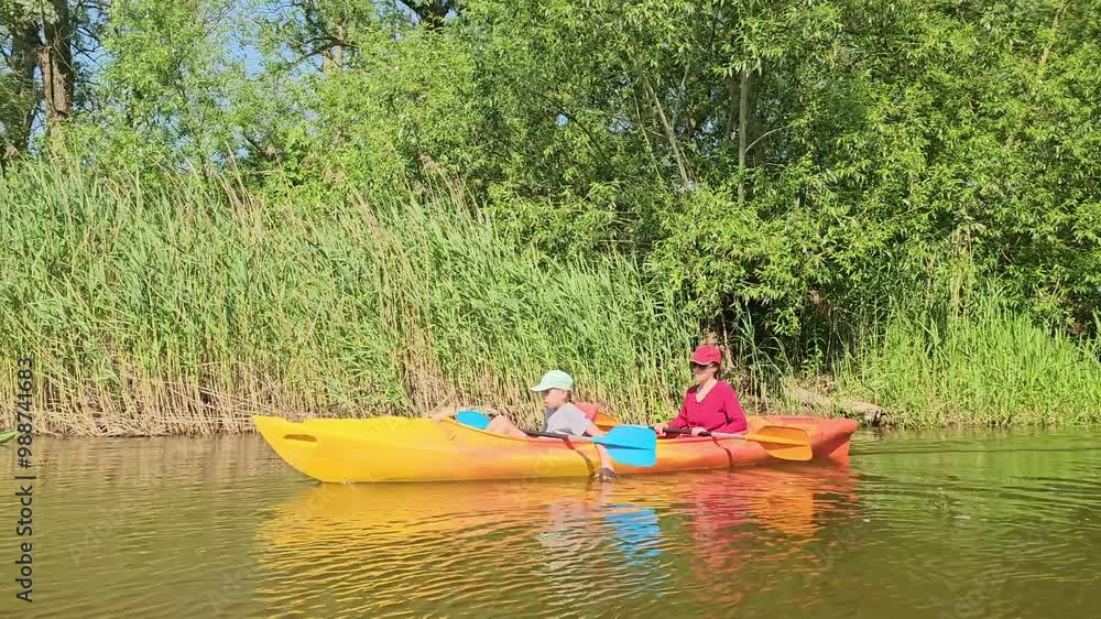 vacation with children on kayaks, children's sports, kayaking, family rafting on the river, sports in summer, weekend in nature, boy eats apple, vacation with children on kayaks, children's sports, kayaking, family rafting on the river, sports in summer, weekend in nature, boy eats apple,