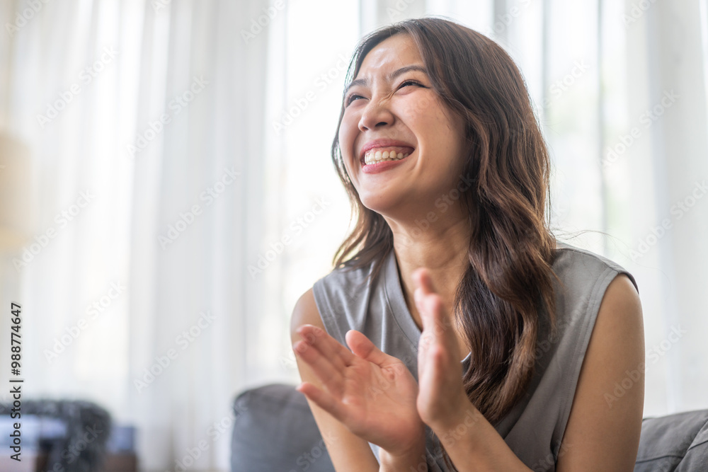 Excited asian woman expressing joy at home, cheerful and happy facial expression, positive emotions, surprised female reaction, happiness and delight, lifestyle, young woman celebrating good news Excited asian woman expressing joy at home, cheerful and happy facial expression, positive emotions, surprised female reaction, happiness and delight, lifestyle, young woman celebrating good news