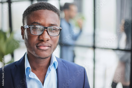 Handsome young man in design office posing at camera