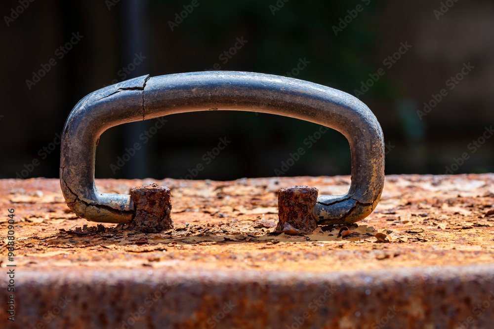 Old cracked handle on a rusty metal box, closeup Old cracked handle on a rusty metal box, closeup