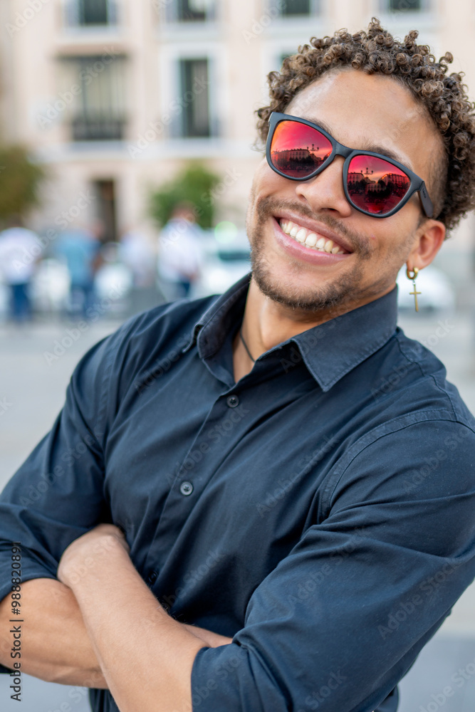 Man in Sunglasses with Arms Crossed Smiling Confidently Man in Sunglasses with Arms Crossed Smiling Confidently