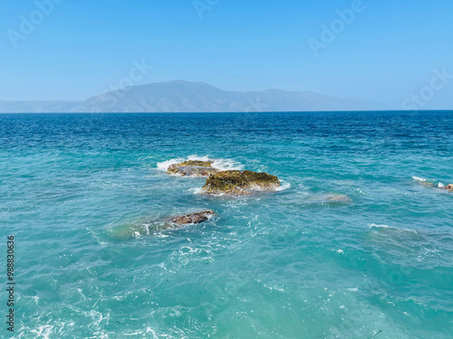 Rocky beach and crystal turquoise water of Ionian Sea in Albania. photo