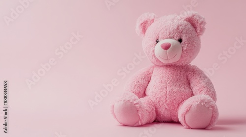 A pink teddy bear sitting on a light pink background, symbolizing childhood and affection.