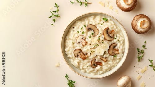 A creamy mushroom risotto garnished with herbs, served in a bowl with fresh mushrooms nearby.