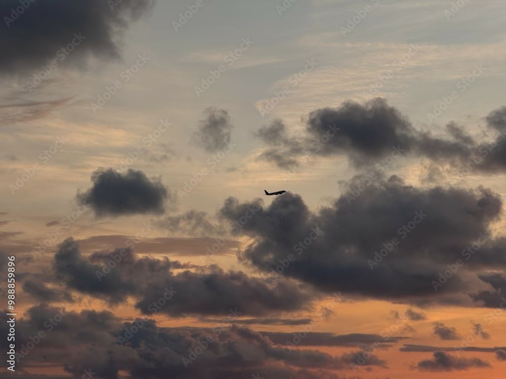 Airplane Silhouetted Against Dramatic Sunset Clouds Airplane Silhouetted Against Dramatic Sunset Clouds