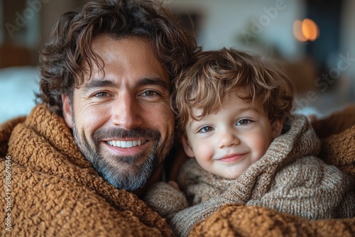 Joyful Bonding: Dad and Son Share Laughter and Cuddles on the Sofa in Their Cozy Living Room