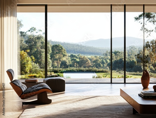 A large window in a living room with a view of the mountains. A chair is in front of the window