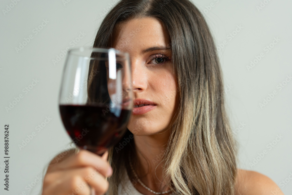 Young woman with red wine gazing at camera: wine tasting, ombre hair, portrait, sensory experience, sommelier, natural beauty Young woman with red wine gazing at camera: wine tasting, ombre hair, portrait, sensory experience, sommelier, natural beauty