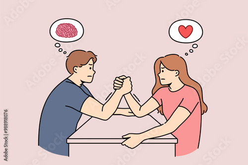 Gender conflict between man and woman engaged in arm wrestling, and thinking with heart or brain. Difference rational and emotional ways of thinking causes gender conflict in couple