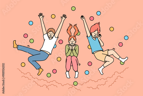 Children jump in pool with balls, laughing and enjoying opportunity to frolic with friends from primary school. Pool with balls in amusement park with little boys and girls diving from great height
