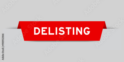 Red color inserted label with word delisting on gray background