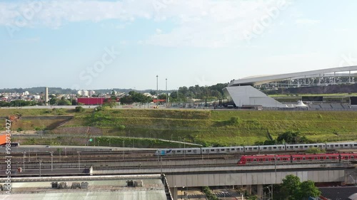 Close-up aerial of train passing near Arena Corinthians